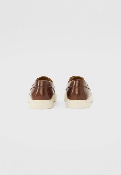 Brown leather shoes with a smooth finish, featuring a rounded toe and a cream-colored sole. Includes subtle stitching details.