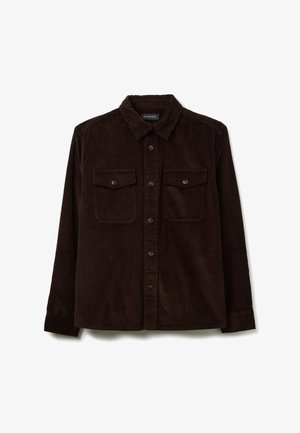 Chemise en velours côtelé marron avec un col, fermeture à boutons sur le devant, deux poches poitrine et texture côtelée. Manches longues avec poignets à boutons.