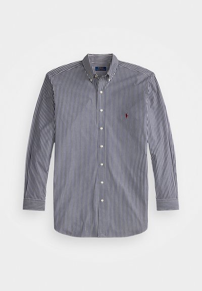 Μπλούζα με μακριά μανίκια σε ναυτικό και λευκό ριγέ σχέδιο, με κολάρο που κουμπώνει και μικρό κεντημένο λογότυπο στο στήθος. Κατασκευασμένη από ελαφρύ ύφασμα.