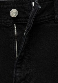 Black denim jeans feature a metal button at the waist, a zip fly with a silver zipper, and a smooth, textured fabric.