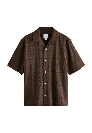 Brown short-sleeve shirt made of textured fabric featuring embroidered patterns and decorative cut-outs, with white buttons and a collar.