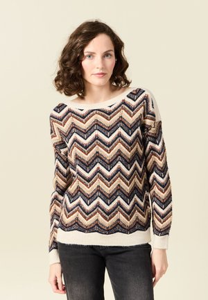 Gebreide trui met een zigzagpatroon in beige, marineblauw en roestkleur. Beschikt over een brede halslijn en geribde manchetten en zoom. Zachte textuur.