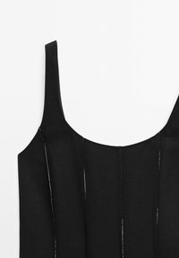 Black sleeveless dress with a rounded neckline, featuring visible stitching details and a smooth fabric texture. Simple, fitted design.
