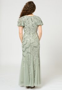 Langes, mintgrünes Kleid mit paillettenbesetzten BlattsMustern, durchsichtigen Faltärmel und einem taillierten Oberteil. Reißverschlussverschluss auf der Rückseite. Glatte Textur.
