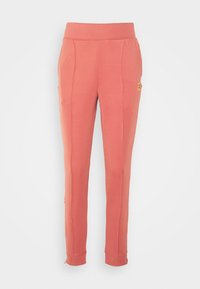 Calças jogger cor pêssego com um design afunilado, cintura elástica, bolsos laterais e detalhes com fecho na bainha.