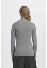 Přiléhavý šedý rolák, měkký úplet, dlouhé rukávy, žebrované manžety a lem, bezešvý design, pohled ze zad.