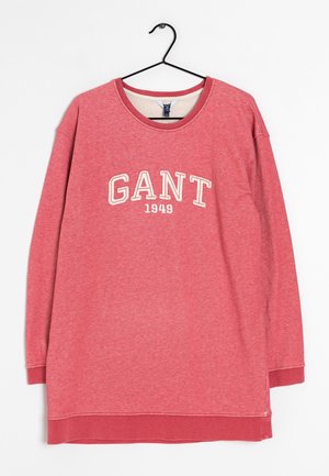 Sweat-shirt rouge à manches longues avec "GANT 1949" imprimé en blanc sur la poitrine, présenté sur un cintre noir sur un fond blanc.