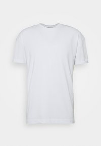 White T-shirt made of cotton. Classic crew neck, short sleeves, straight hem with double stitching. Soft texture, no visible patterns or logos.