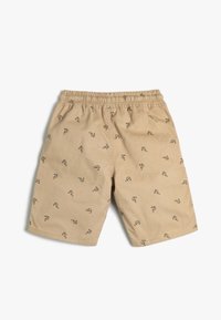 Shorts beiges avec une taille élastique cousue, ornés de motifs de crevettes noires. Fabriqués en tissu léger, adaptés pour un usage décontracté.