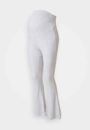Gray maternity leggings made of soft fabric, featuring a flared hem and a stretchy waistband to accommodate a growing belly.