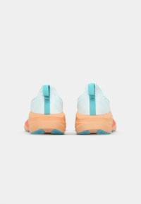Lys blå mesh sneakers med en myk oransje og rosa såle, med en trekkrem og teksturerte mønstre på den øverste delen.