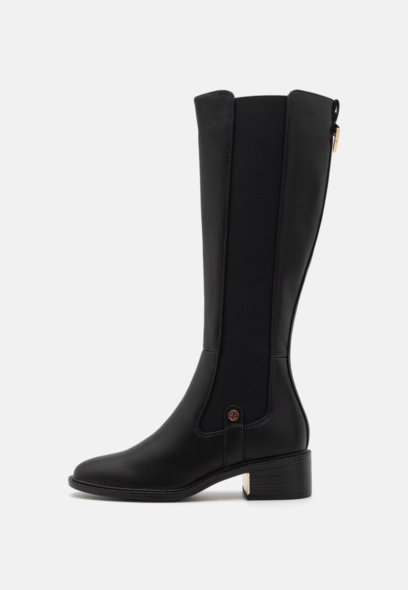 Schwarze kniehohe Stiefel aus glattem Leder mit elastischen Seitenpaneelen, einem dekorativen Knopf und einem niedrigen Blockabsatz mit goldenen Akzenten.