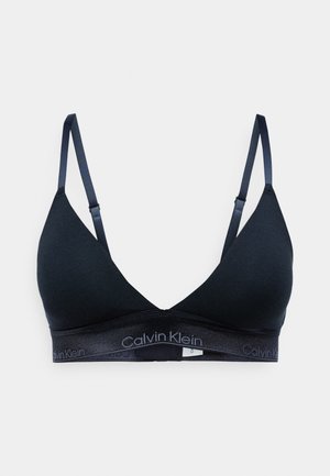 Melnas kokvilnas bralette ar trīsstūra formu kausiem, regulējamām siksniņām un gludu apdari. Apakšā ir iezīmēta elastīga josta.