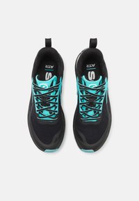 Sport shoes with a black mesh upper, turquoise accents, and black laces. Features a padded collar and a textured sole for grip.