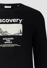 Czarna bluza z długim rękawem z białym wzorem graficznym przedstawiającym góry oraz tekstem "DISCOVERY" w wyraźnej typografii.