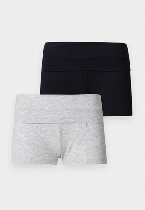 Deux paires de shorts extensibles, une noire et une gris clair, pliées et exposées à plat sur un fond blanc.