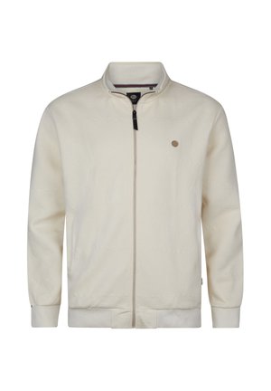 Chaqueta cremosa clara con cremallera, hecha de tela texturizada con patrón de espiga. Cuenta con cuello alto y pequeño emblema en el pecho.