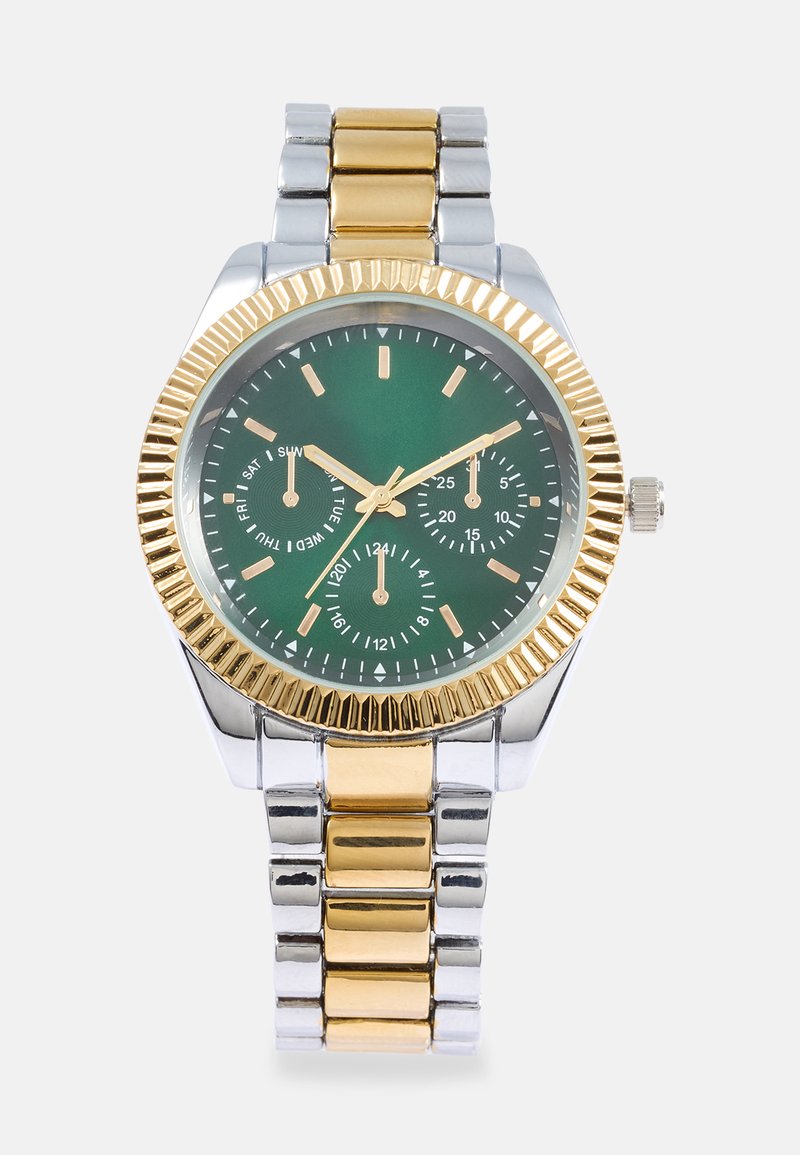 Gold and silver watch with a green dial, three sub-dials, and a ridged gold bezel. Features a two-tone metal bracelet with shiny links.
