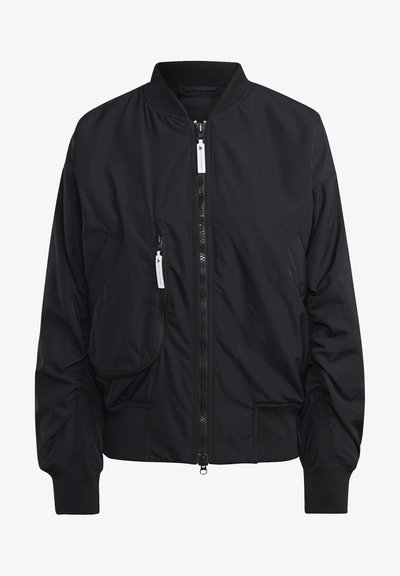 Must must jacket, mis smooth kangast; sisaldab esikäppa, külje tõmbluku taskut ja soonikuid. Lihtne kujundus, ilma mustriteta.