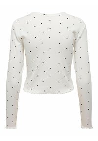 Haut blanc à manches longues avec des pois noirs, texture côtelée et ourlet festonné. Dispose d'un col arrondi et d'une coupe ajustée.