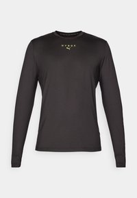Černé atletické tričko s dlouhým rukávem, hladká textura, s žlutým logem "HYROX" na hrudi a značkou na rukávu. Kulatý výstřih, přiléhavý střih.