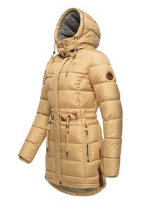 Beige puffer jacket with a textured gray hood lining, adjustable drawstring waist, and multiple zippered pockets. Features leather accents.