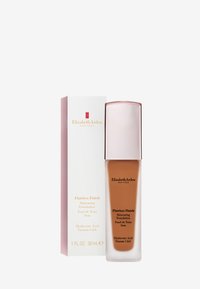 Flawless Finish foundation i en glasflaska med rund form och metallisk roséguldkork. Beigefärgad vätska inuti, förpackad i en vit och rosa låda.