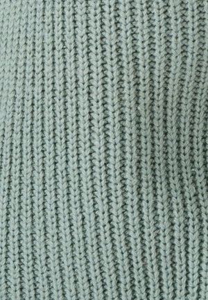 Tela de punto verde claro con una textura acanalada, que presenta líneas verticales uniformemente espaciadas y una apariencia suave y peluda.