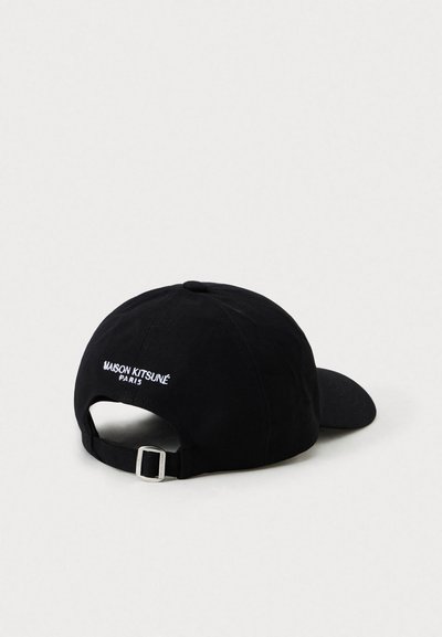 Black adjustable baseball cap with "MAISON KITSUNÉ PARIS" embroidered in white on the back, resting on a plain light surface.