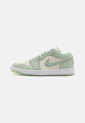 Nike Air Jordan 1 Low; features light green and cream leather, suede accents, perforated toe, white midsole, and translucent green outsole.