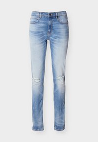 Jean skinny bleu clair avec lavage délavé et déchirures usées aux deux genoux, avec poches avant et passants de ceinture.