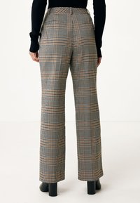 Plaid trousers with a wide-leg design in gray, white, and orange. Features a high waist and rear pockets, displayed against a plain background.
