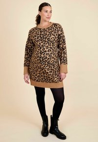Pruun kardigan Kleid musta leopardi mustriga, sooniku ja mansettidega. Kantud mustade sukkpükste ja pahkluuni saapadega. Sile tekstuur.