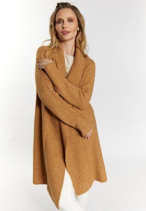 Oversized, lange mouwen cardigan in warme amber, gemaakt van getextureerde brei stof, met een diepe schuilkraag en open voorkant.