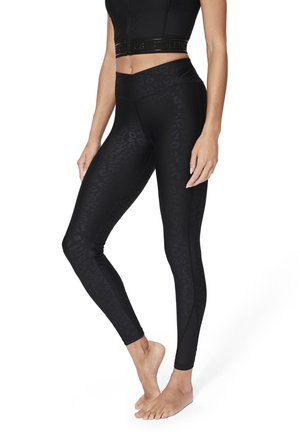 Leggings neri con un sottile motivo a leopardato, vita alta e tessuto liscio e elasticizzato per l'abbigliamento sportivo.