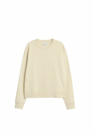 Lysebeige sweatshirt med rund halsudskæring, faldende skuldre og ribstrikkede ærmekanter. Lavet af blødt stof med en let cropped kant.