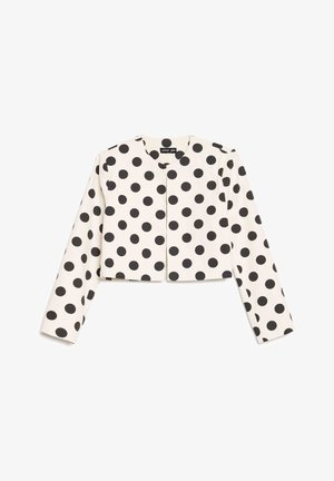 Balta īsa žakete ar garām piedurknēm un melnu polka punktu rakstu, apaļu kakla izgriezumu bez redzamām pogām vai aizdares.