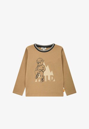 Long-sleeve, tan cotton shirt with black accents, featuring a bear graphic and mountain design. "WILD" text in white below the graphic.