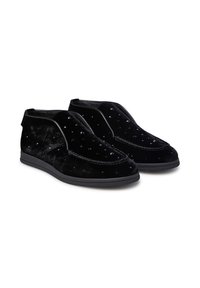 Scarpe slip-on in velluto nero con un motivo testurizzato e decorate con piccoli borchie. Hanno un tacco sottile e una suola in gomma resistente.