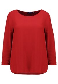 Chemise rouge à manches longues avec un col rond, en tissu lisse, dotée d'une coupe décontractée et d'un ourlet légèrement arrondi.