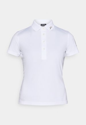 Valge polo särk lühikeste varrukatega, kolme nupuga kaelus ja kuldne logo krael. Sile kangas ja kohandatud sobivus.