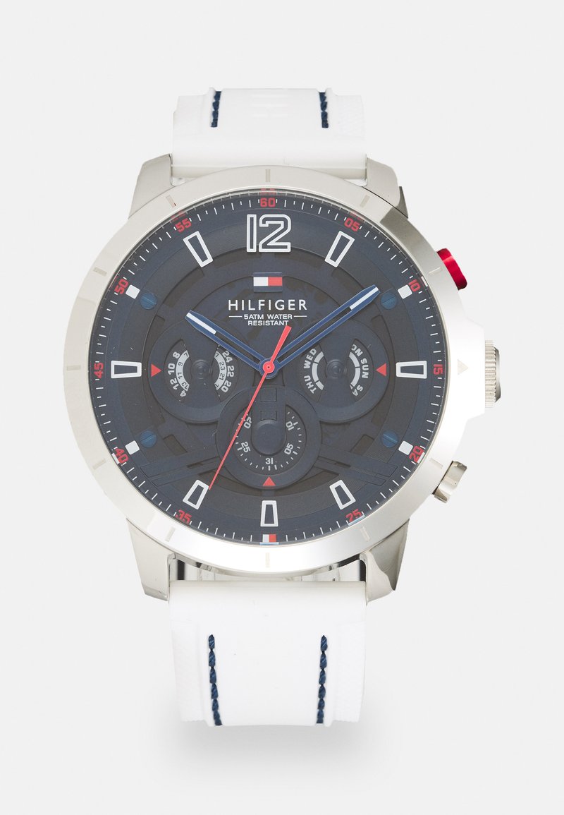 Silver-tone men's watch with a dark dial, white silicone strap, and red accents. Features date, day display, and stopwatch functions.