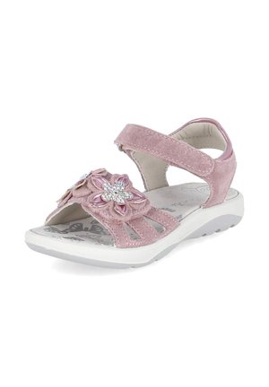 Pink suede child’s sandal with adjustable strap, floral decoration with rhinestones, and white cushioned sole with butterfly print insole.