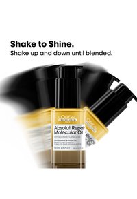 L’Oréal Absolut Repair Molecular Oil-Flasche wird geschüttelt, um die Bi-Phasen-Formel zu vermischen, mit Anweisung, die Flasche auf und ab zu schütteln, bis die Mischung homogen ist.