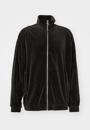 Schwarze Samtjacke mit Reißverschluss, hohem Kragen, gerippten Bündchen und Saum. Verfügt über diskrete Seitentaschen und ein kleines Logo auf der Brust.