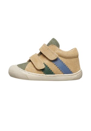 Sneaker in suede beige con strisce zigzag verdi e blu, dotato di due cinturini in Velcro e una suola in gomma bianca textured.