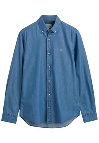 Denimskjorte i lyseblå med nedknappet krage, frontknapper og logo på brystet. Har avrundet fald og lange ermer.