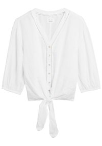 Blusa bianca in lino con maniche a tre quarti, ampio scollo a V, chiusura con bottoni frontale e vita annodata. Delicate cuciture lungo il colletto e i bottoni.
