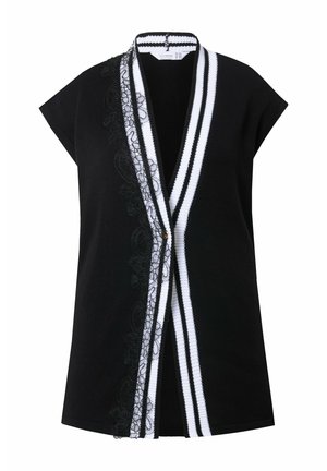 Zwarte mouwloze top met witte gestreepte afwerking en een kantdetail aan de linkerkant. Heeft een V-hals en een knoopsluiting aan de voorkant.