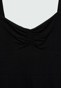 Vêtement sans manches noir avec un détail froncé au centre de l'encolure et une large ceinture autour de la taille.